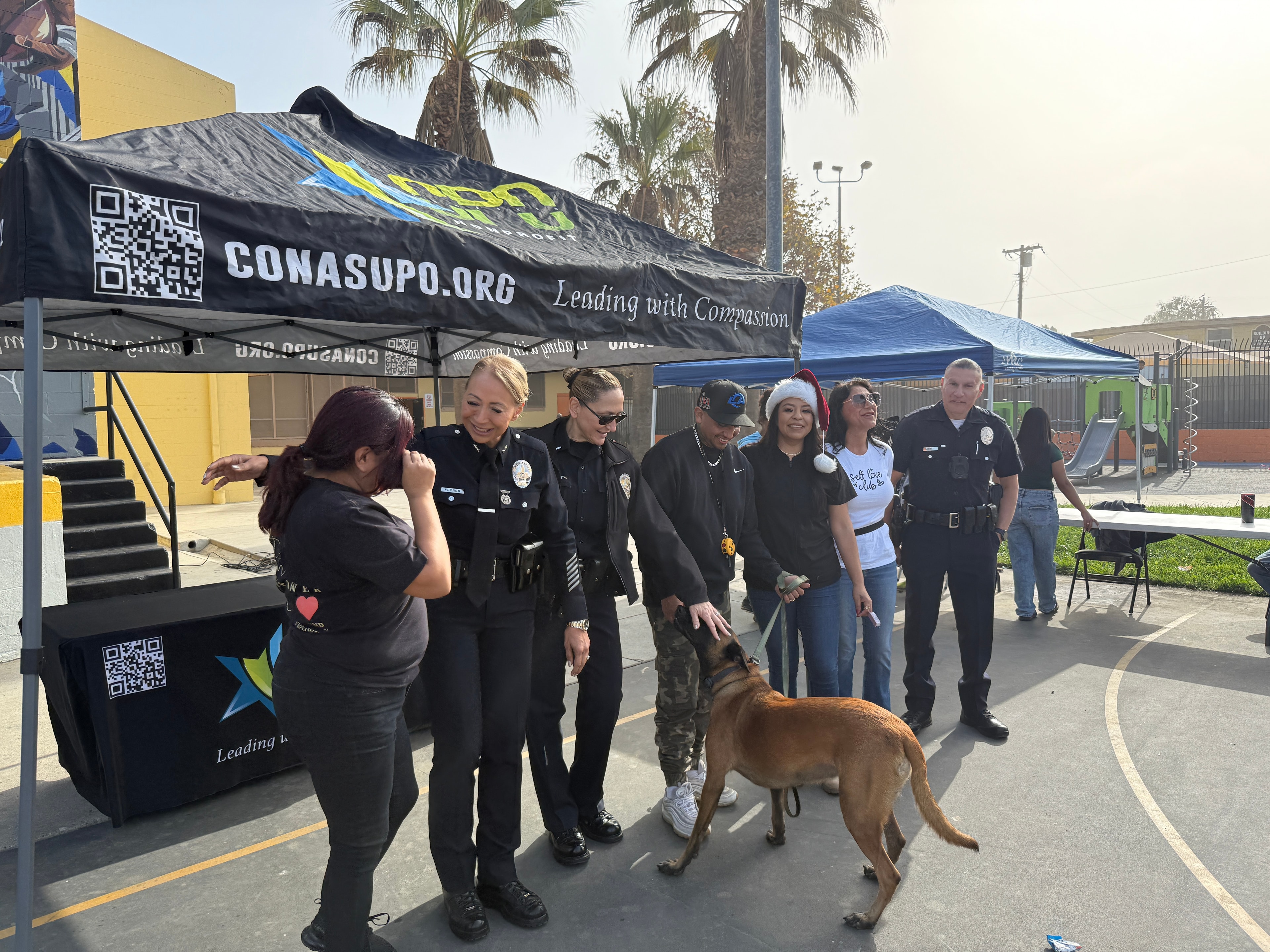 Marybel at a CONASUPO community event alongside law enforcement and neighbors